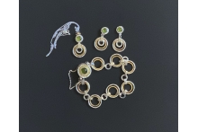 Silver and gold bracelet, earrings, and pendant set